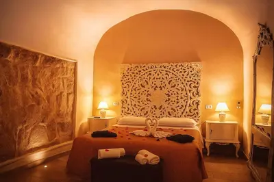 Letto o letti in una camera di SPA SUITE SICILIA - Intera casa con spa privata Jacuzzi Sauna Bagno di Vapore