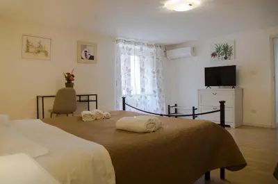Letto o letti in una camera di GuestHost - Casa Alchisi - Teatro Romano Cozy Apartment