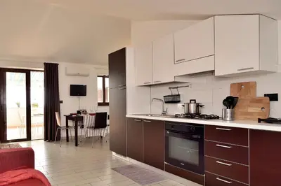 Cucina o angolo cottura di Attico Vista Mare e Piscina