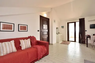 TV o dispositivi per l'intrattenimento presso Attico Vista Mare e Piscina