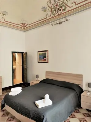Letto o letti in una camera di Residenza Diana- Ortigia Holidays