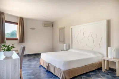 Letto o letti in una camera di VOI Arenella Resort