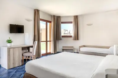 Letto o letti in una camera di VOI Arenella Resort