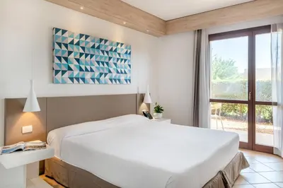 Letto o letti in una camera di VOI Arenella Resort