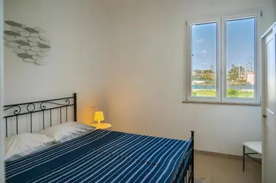 Letto o letti in una camera di Cicirata Sea Beach - Sicilia Vacanza