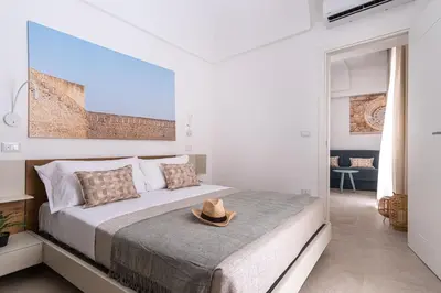 Letto o letti in una camera di Palazzo Amalfitania