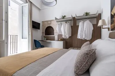 Letto o letti in una camera di Palazzo Amalfitania