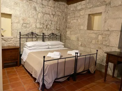 Letto o letti in una camera di Agriturismo Il Melograno