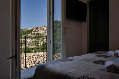 Letto o letti in una camera di La Terrazza sul Barocco