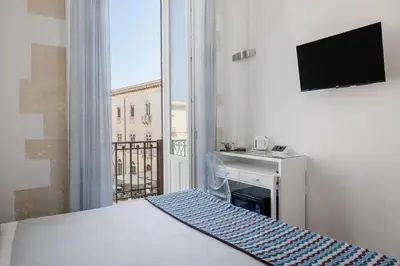 Letto o letti in una camera di Archimede Charm B&B - Historical Palace in Ortigia