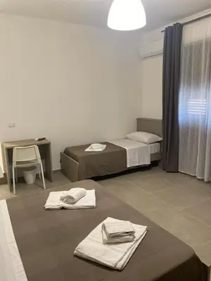Letto o letti in una camera di AEROPORTO KATANÈ ROOMS