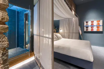 Letto o letti in una camera di BASTIÒ PRIVATE SUITES