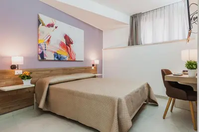 Letto o letti in una camera di Archimede's Rooms