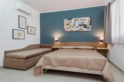 Letto o letti in una camera di Archimede's Rooms