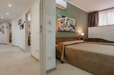 Letto o letti in una camera di Archimede's Rooms