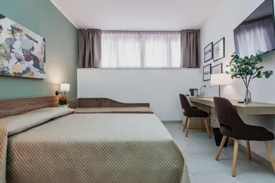 Letto o letti in una camera di Archimede's Rooms
