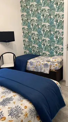 Letto o letti in una camera di LA PERLA BLU DI FONTANE BIANCHE