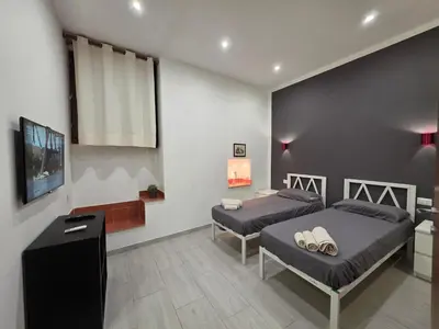 Letto o letti in una camera di Domus Odeon la casa nel parco archeologico di Catania