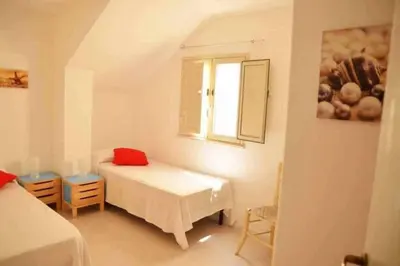 Letto o letti in una camera di Casa delle Palme sulla spiaggia
