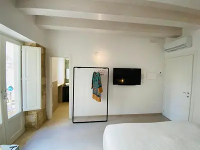 Letto o letti in una camera di Residence Le Tre Grazie - Appartamento Tàlia