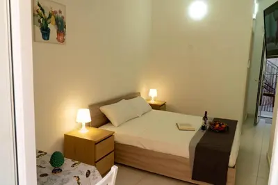 Letto o letti in una camera di Casa Charm RosaApartmentsOrtigia