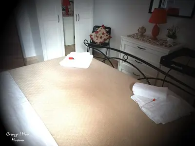 Letto o letti in una camera di Casuzze I Mori Museum Alloggi di Charme tra Mare Natura e Tradizione Siciliana