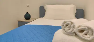 Letto o letti in una camera di Casa Vacanze Rainbow, Siracusa