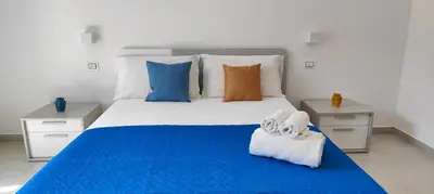 Letto o letti in una camera di Casa Vacanze Rainbow, Siracusa
