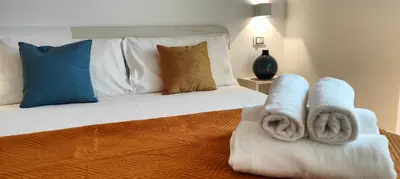 Letto o letti in una camera di Casa Vacanze Rainbow, Siracusa