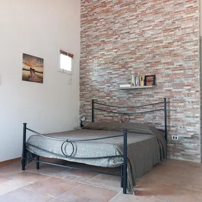 Letto o letti in una camera di Dimore del Carrubo - openspace con piscina